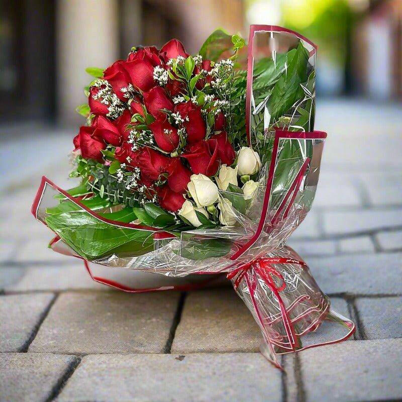 Romantic Roses Arrangement wrapped bouquet with red and white roses.