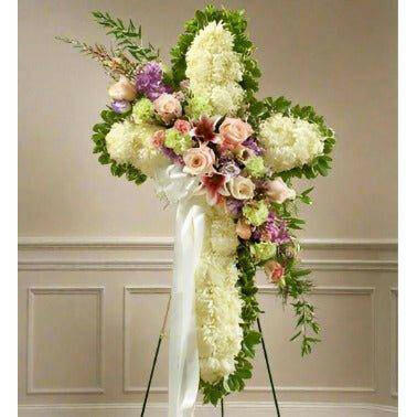 Sympathy Standing Cross Pastel heartfelt arrangement of fresh flowers like roses cushions and greens.