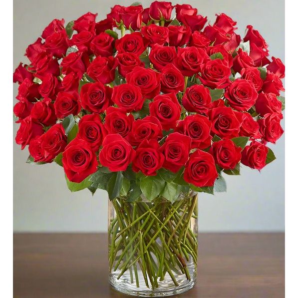 Bouquet of red roses in a clear glass vase.