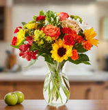 Floral arrangement with fall colors showing sunflowers, roses, carnations and fillers