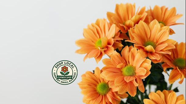 Bouquet of orange flowers with a 'Shop Local' logo on a light gray background