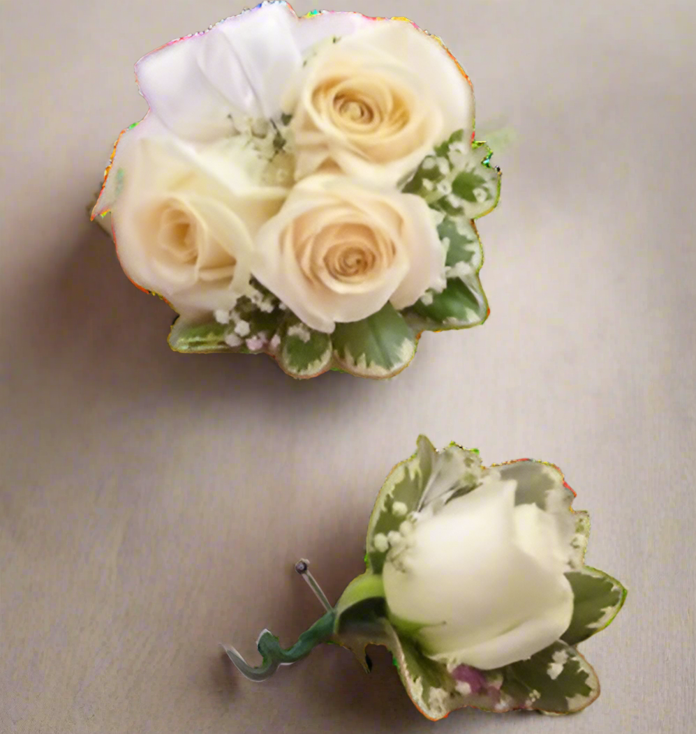 three roses corsage and one rose boutonniere with greens and white ribbon.