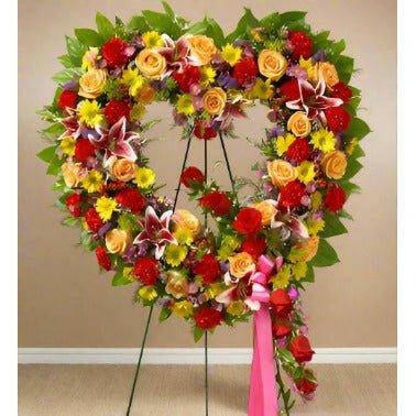 Always Remember Floral Heart Tribute - Bright Floral standing spray with yellow and red roses with fillers and greens.