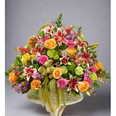 Colorful Sympathy Basket with pastel colors like roses, and fillers.