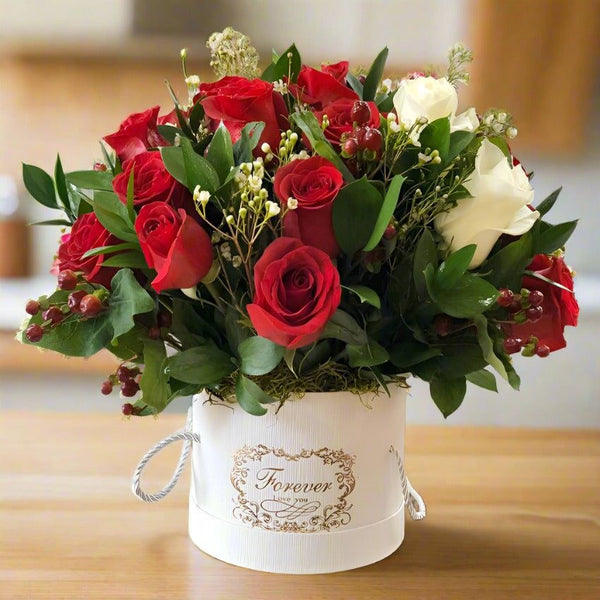 Bouquet of red and white roses in a white vase with the inscription 'Forever, I Love You.'