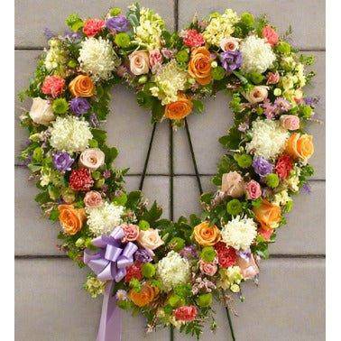 Pastel Floral Heart Tribute with orange yellow and white flowers.