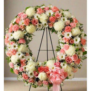 Pink & White Standing Wreath with roses, pomp's and fillers on a standing easel.