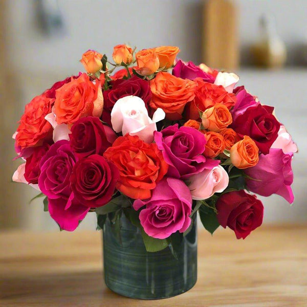 A bouquet of colorful roses in a glass vase.