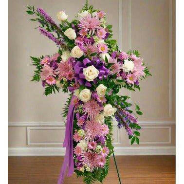 lavender Standing Cross floral tribute. Made with fresh flowers like roses, carnations, and daisy pomp's.