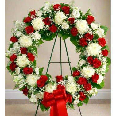 Standing Wreath Red and White: Sympathy Condolences Funeral Flowers with red and white roses and greens.