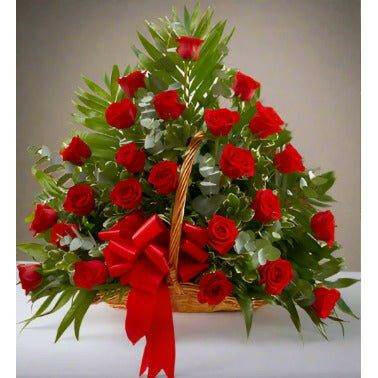 Red sympathy basket floral arrangement with roses, fillers and greens.