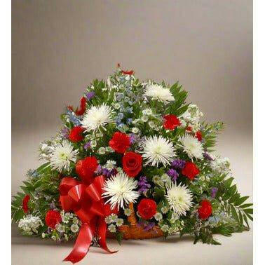 Multi Color Sympathy Basket floral arrangement with roses and mums with a red bow on the left side - Flower Shop in Hollywood