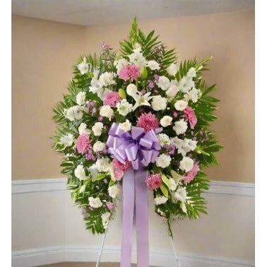 White Lavender Standing Spray with white and lavender color flowers and lavender ribbon in the middle of the arrangement.