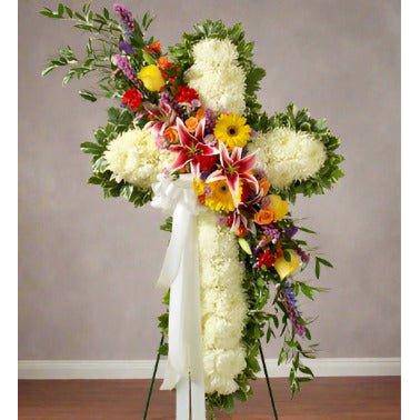 White Standing Cross with white pomp's and mixed color roses and greens.